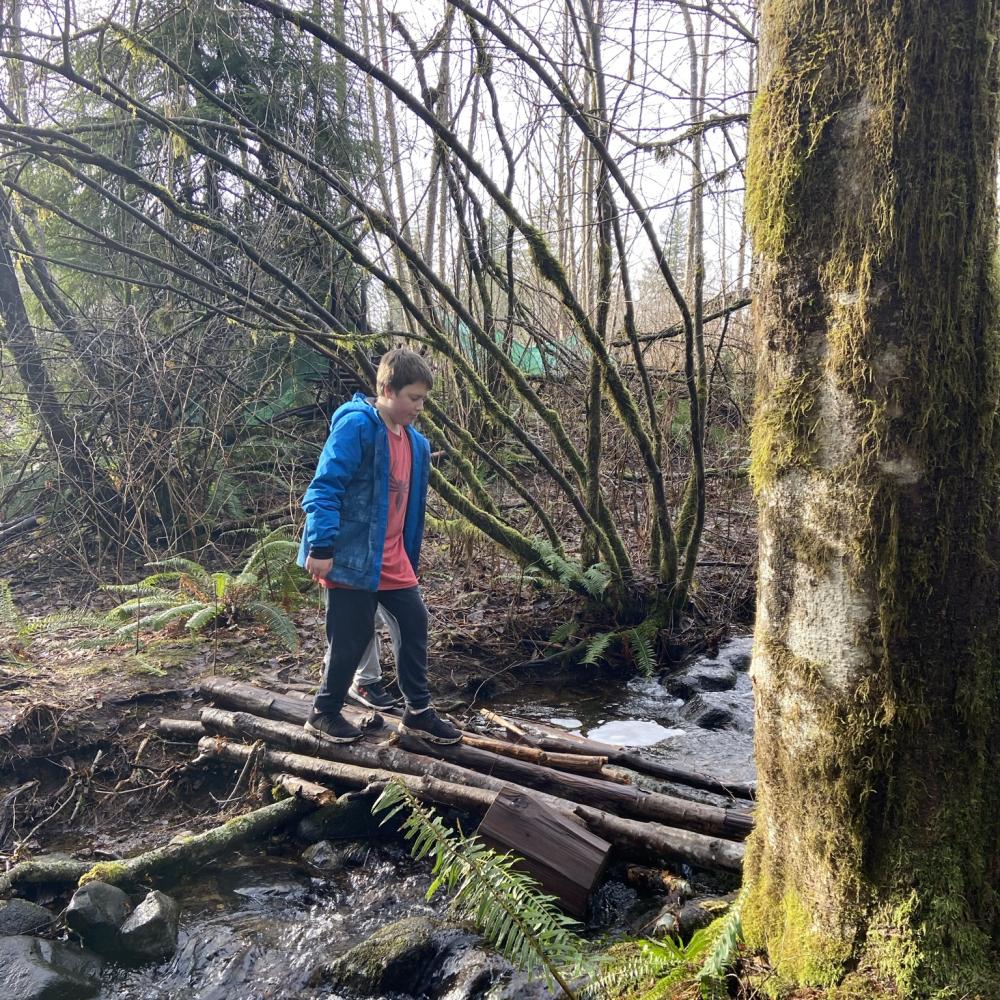 Kid crossing stream